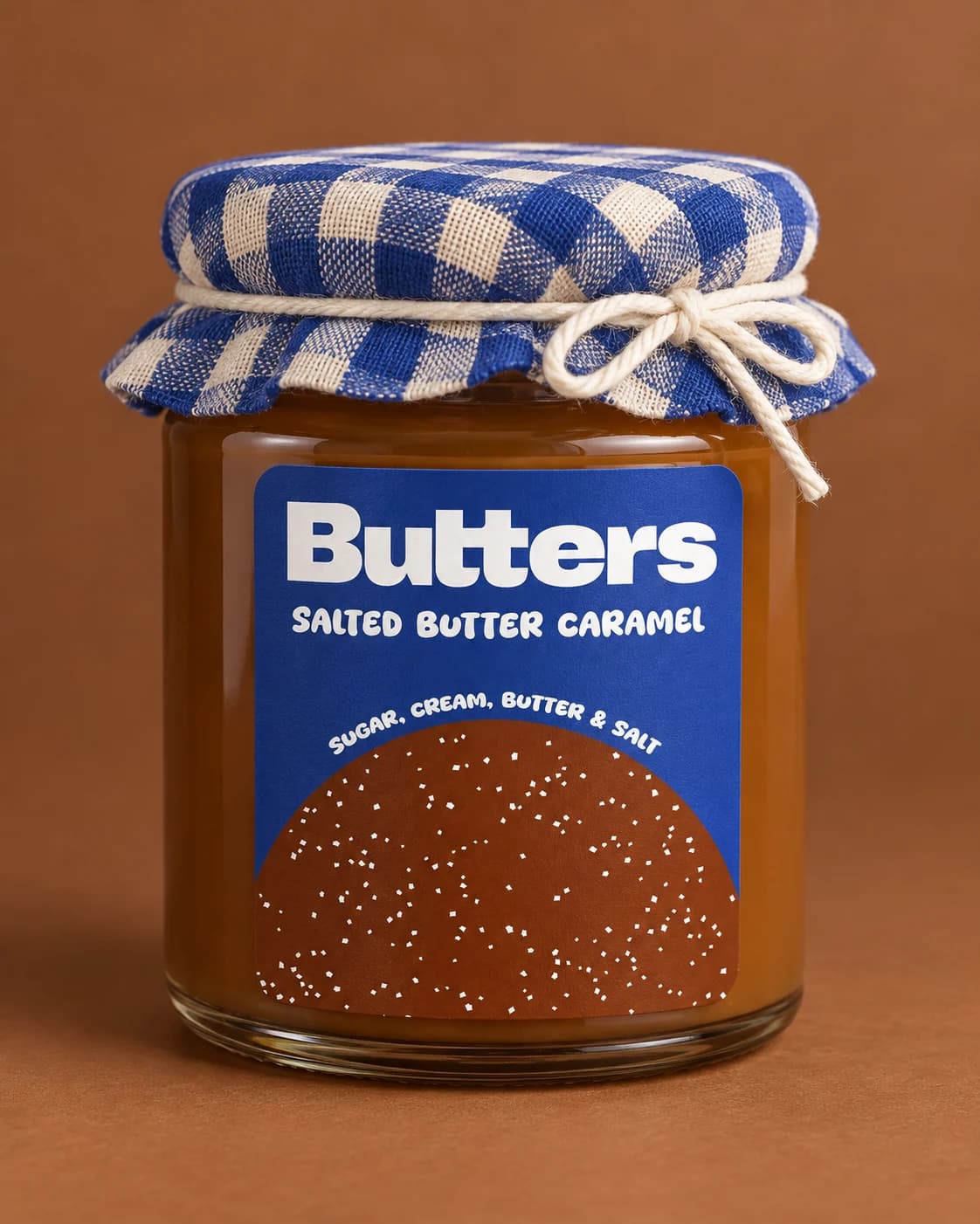 Close-up of the Butters Caramel dome label and blue-and-white checked cloth cap